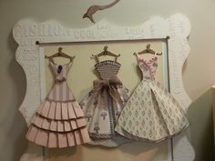 there are three dresses hanging on the wall