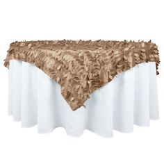 a table topped with a white and brown cloth covered tablecloths on top of it