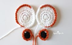 two crocheted orange and white objects on a table