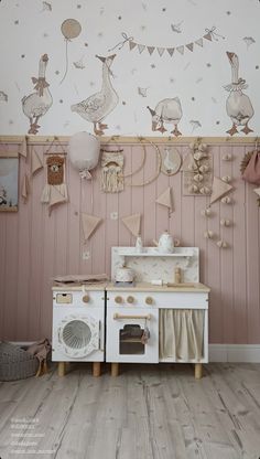 a white stove top oven sitting inside of a kitchen next to a wall with pictures on it