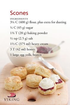 scones on a cutting board with cream and jam