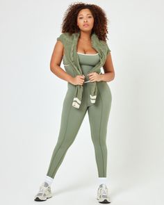 Getting dressed has never been easier than slipping into the Ace jumpsuit. This one-piece features dainty details like princess seams and a criss-cross back cut-out, while also being a performance piece that can get you through any workout. A shelf bra and removable pads keep your girls happy, too. Wear it with the coordinating Hamptons Sweater for a perfectly polished look. Impact level: Medium Activity type: Pilates, Yoga, Walking Jumpsuit Princess seams Adjustable straps Criss cross cutout at Green Sleeveless Jumpsuits And Rompers In Athleisure Style, Sleeveless Jumpsuits And Rompers With Built-in Bra, Green Sleeveless Athleisure Jumpsuits And Rompers, Green Sleeveless Jumpsuits And Rompers For Yoga, Green Sleeveless Athleisure Jumpsuit, Sleeveless Compressive Unitard For Loungewear, Sporty High Stretch Jumpsuit With Built-in Bra, Compressive Sleeveless Jumpsuit With Built-in Bra, Sleeveless Compressive Jumpsuit With Built-in Bra