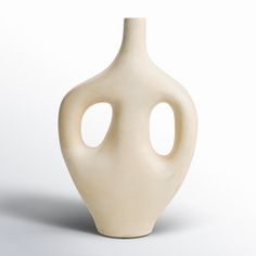 a white vase with two holes in it