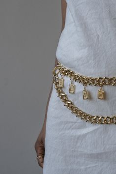 White spring dress styled with gold custom monogram chain belt Metal Jewelry With Adjustable Chain Nameplate, Adjustable Waist Chain As A Gift, Metal Chain Belt For Gifts, Metal Chain Link Belt As Gift, Metal Chain Link Belt For Gift, Gold Waist Chain With Adjustable Chain As Gift, Gold Chain Link Belt As Gift, Gold Chain Link Belt - Ideal Gift, Industrial Piping