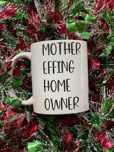 a coffee mug with the words mother effining home owner on it