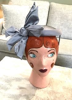 This darling blue/gray satin hat has never been worn. It even has its original price tag! It features three large wired bows. It's in pristine condition. The hat portion is 6 1/4" in diameter. The bows are 7 3/4" in length. Formal Hat With Adjustable Bow, Adjustable Bow Hat For Kentucky Derby, Adjustable Hats With Bow For Kentucky Derby, Formal Hats With Bow And Adjustable Fit, Adjustable Kentucky Derby Hat With Bow, Kentucky Derby Evening Hat With Satin Bow, Formal Adjustable Hat With Bow, Adjustable Mini Hats With Bow For Kentucky Derby, Adjustable Hat With Ribbon For Royal Ascot