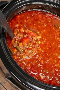 a slow cooker filled with chili and beans