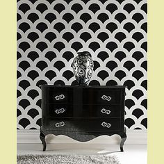 a black and white wallpaper with an ornate design on the sideboard next to a dresser