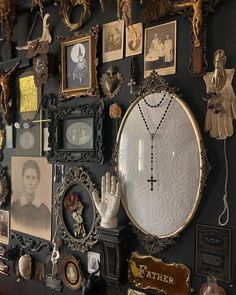 a wall covered in pictures and other items on it's side, including an ornate mirror