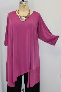 "Your favorite plus size tunic top in a rich Raspberry, polyester spandex  traveler knit . Size 2  fits a size  3X,4X Bust: 60\" total Hips: 82\" Length at longer side: 41\" Length at shorter side: 31\" This asymmetric tunic top is in a light weight poly spandex knit. . A great top to dress up, wear this top dressy or casual. With 3/4 length sleeves, jewel neck,princess seaming in back and front, this top hangs longer on one side, comes to a point on center side, and has an inserted detail on th Asymmetric Tunic, Plus Size Tunic, Tie Waist Top, Black Wide Leg Pants, Pantalon Large, Jewel Neck, Womens Tunics, Tunic Top, Beautiful Outfits