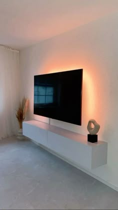 a large flat screen tv mounted to the side of a wall in a living room