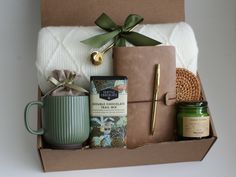 a gift box containing coffee, candles, and other items for someone's special occasion