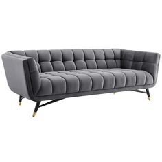 a gray couch with gold legs and an upholstered backrest, on a white background