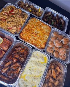 many trays of different types of food