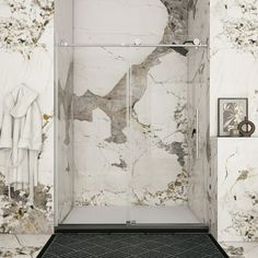 a bathroom with marble walls and flooring in the shower area, along with a rug on the floor