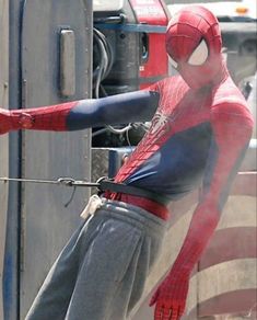 a man dressed as spider - man on the set of the amazing spiderman