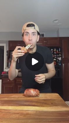 a man is brushing his teeth while standing in front of a cutting board with food on it