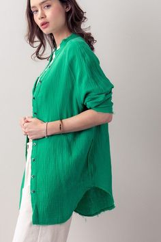 Unleash your summer wardrobe with this plush cotton shirt. Soft to the touch and lightweight, the oversized boyfriend cut and one pocket provide a stylish cover-up when the weather turns warm. The distressed hem adds an edgy finishing touch for a look that is both elegant and modern. Perfect for making a fashion statement this summer. Green Relaxed Fit Blouse For Loungewear, Summer Green Shirt For Daywear, Green Casual Shirt For Summer, Green Shirt For Summer Daywear, Oversized Green Blouse For Day Out, Chic Green Shirt For Daywear, Green Summer Tops With Pockets, Green Summer Shirt With Roll-up Sleeves, Oversized Green Cotton Blouse