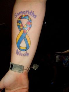 a person with a blue and yellow ribbon tattoo on their arm that says, samniha nicole