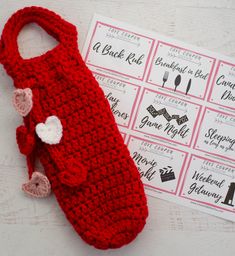 a crocheted red bag sitting on top of a table next to coupons