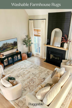 a living room with couches and a rug on the floor