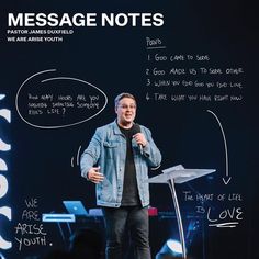 a man standing at a podium in front of a screen with words written on it