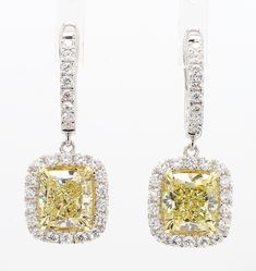 RareGemWorld's classic GIA certified diamond earrings. Mounted in a beautiful 18K Yellow and White Gold setting with natural cushion cut yellow diamonds. The yellow diamonds are surrounded by round natural white diamond melee. These earrings are guaranteed to impress and enhance your personal collection! Total Weight: 5.24cts Natural Light Yellow Cushion Cut Diamond Measurement:  7.25 x 6.90 x 4.72 mm Carat Weight: 2.17cts Clarity Grade: VS1 Natural Light Yellow Cushion Cut Diamond Measurement: 7.39 x 7.06 x 4.75 mm Carat Weight: 2.23cts Clarity Grade: VVS2 Natural Round White Diamonds 18K Yellow/White Gold All diamonds are guaranteed natural International Shipments: Please note that customers are responsible for all import duties and taxes applicable to the country of shipment Returns: Re Yellow Diamond Earrings, Yellow Diamond Earring, Yellow Cushion, Yellow Cushions, Yellow Diamonds, Natural Cushions, White Gold Set, Cushion Diamond, Cushion Cut Diamonds