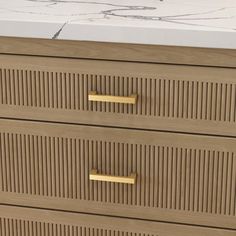 a close up of a wooden dresser with two drawers and gold handles on the front