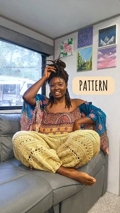 a woman sitting on top of a couch in front of a window with the words pattern above her head