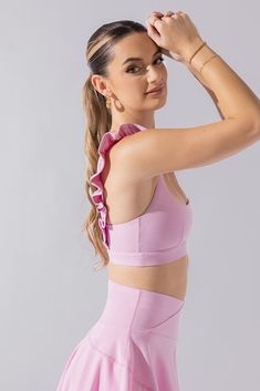 It’s a sports bra straight out of a romance novel. This bra features the most romantic, ruffled shoulder straps, a daring square neckline, and a flirty low back. Compression Level:  Performance Level: Pink Activewear With Built-in Bra For Relaxation, Pink Sporty Bra With Removable Pads, Sporty Pink Bra With Removable Pads, Pink Fitted Activewear With Removable Bra Pads, Sporty Pink Sports Bra With Removable Pads, Fitted Pink Activewear With Removable Bra Pads, Pink Gym Bra With Removable Pads, Pink Workout Bra With Removable Pads, Pink Sports Bra With Removable Pads For Gym