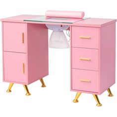 a pink desk with gold legs and drawers