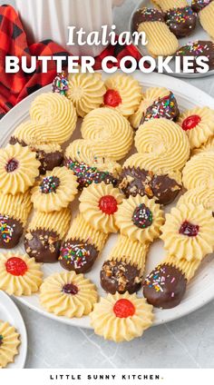 italian butter cookies with sprinkles and chocolate on a white plate next to other desserts