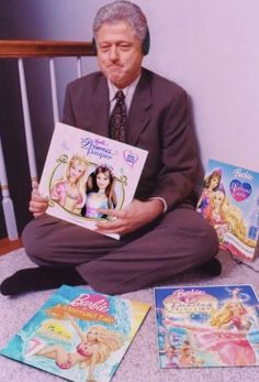 an older man sitting on the floor with some books in front of him and other children's books around him