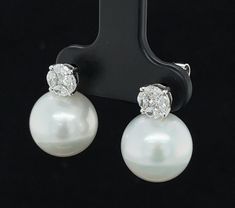 These elegant South Sea pearl and diamond earrings are a timeless classic for any high jewelry collection. The 11.50mm South Sea pearls are stunning - perfectly round and blemish-free, with gorgeous luster! We have paired these gems with diamond "rounds" created by arranging sparkling marquise-shaped diamonds around princess cut centers, giving the illusion of larger, single diamonds! Large pearl earrings are a statement of refinement, sophistication and natural beauty. These earrings belong in Luxury Diamond Pearl Earrings For Formal Occasions, Luxury Diamond Pearl Earrings For Formal Events, Luxury Diamond Earrings With Pearl Drop, Formal Diamond Pearl Earrings With Brilliant Cut, Formal Brilliant Cut Diamond Pearl Earrings, Luxury Diamond White Diamond Earrings With Pearl Drop, Timeless Diamond Pearl Earrings, Luxury Brilliant Cut Pearl Earrings For Evening, Luxury Pearl Earrings With Diamond Accents, Round Cut