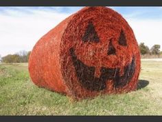 a hay bale with a pumpkin face drawn on it