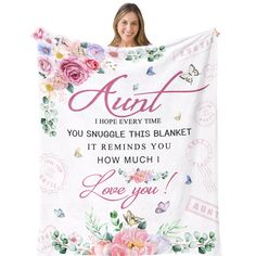 a woman is holding up a blanket with flowers and butterflies on it that says, i hope every time you snuggle this blanket