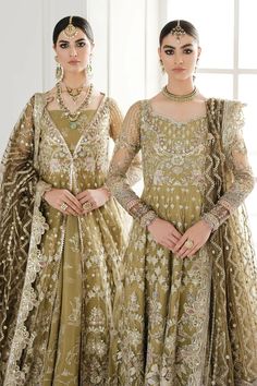 two women in green dresses standing next to each other with jewelry on their heads and hands