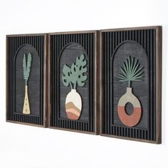 three framed art pieces with plants on them