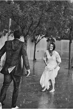 a man and woman are walking in the rain