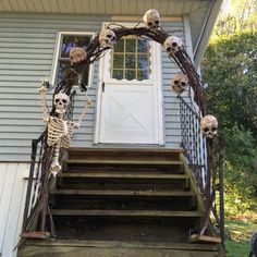 skeleton decorations on the front steps of a house