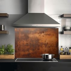 a kitchen with a large copper splash on the wall