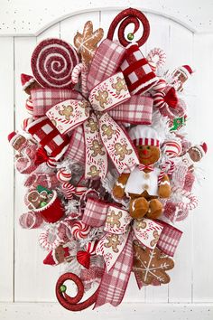 a christmas wreath with gingerbreads, candy canes and candies on it