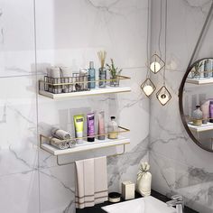 a bathroom with marble walls and shelving above the sink in front of a round mirror