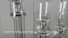 three clear glass candlesticks are standing next to each other