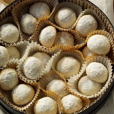 a pan filled with pastries covered in powdered sugar