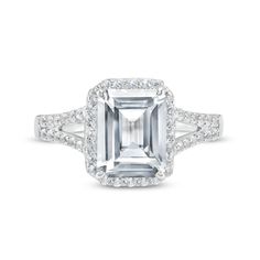 an emerald - cut diamond ring with pave set diamonds on the shoulders and sides