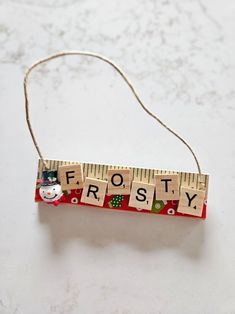 a wooden ruler with the word frosty spelled out in letters on top of it