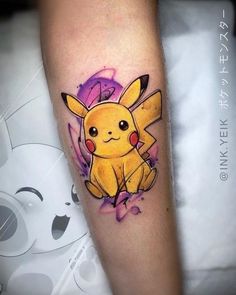 a tattoo with a cartoon pikachu on it's arm and watercolor splashs