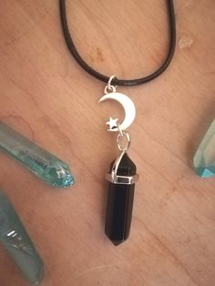 🖤 Here is a beautiful Black obsidian necklace, on a black 20 inch adjustable faux leather cord. With a silver Moon & Star charm!  🖤Enjoy the protective ground benefits of wearing this crystal pendant!   *Please choose your preferred finish from the drop down menu- *Faux leather cord - 20inch Silver plated -20 inch Stainless Steel -20 inch Black Jewelry With Adjustable Cord For Healing, Adjustable Black Moon Charm Necklace, Nickel-free Black Spiritual Necklaces, Black Spiritual Nickel-free Necklace, Black Nickel-free Spiritual Necklaces, Nickel-free Black Spiritual Necklace, Mystical Black Necklace For Gift, Spiritual Black Dangle Necklaces, Mystical Black Jewelry Gift