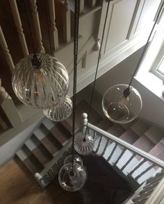 an overhead view of a staircase with chandeliers hanging from it's sides